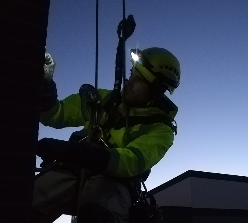 Rope access technician working on a high-rise building in Toronto