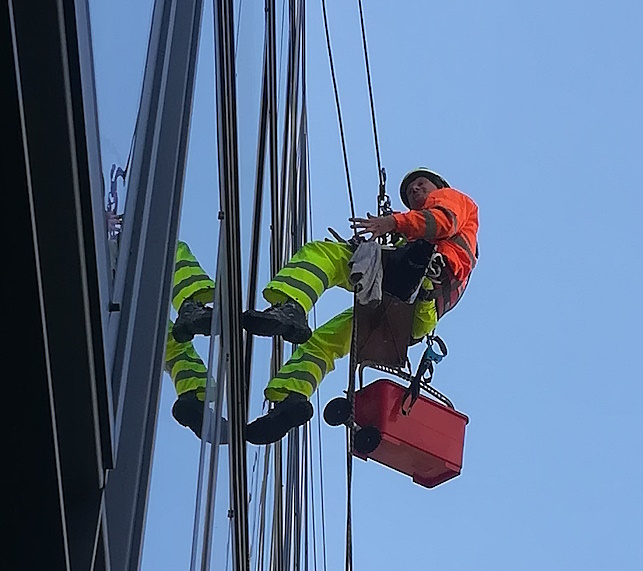 Rope access technician working on a high-rise building in Toronto